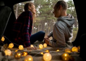 couple enjoying their date night in the van surrounded by lights