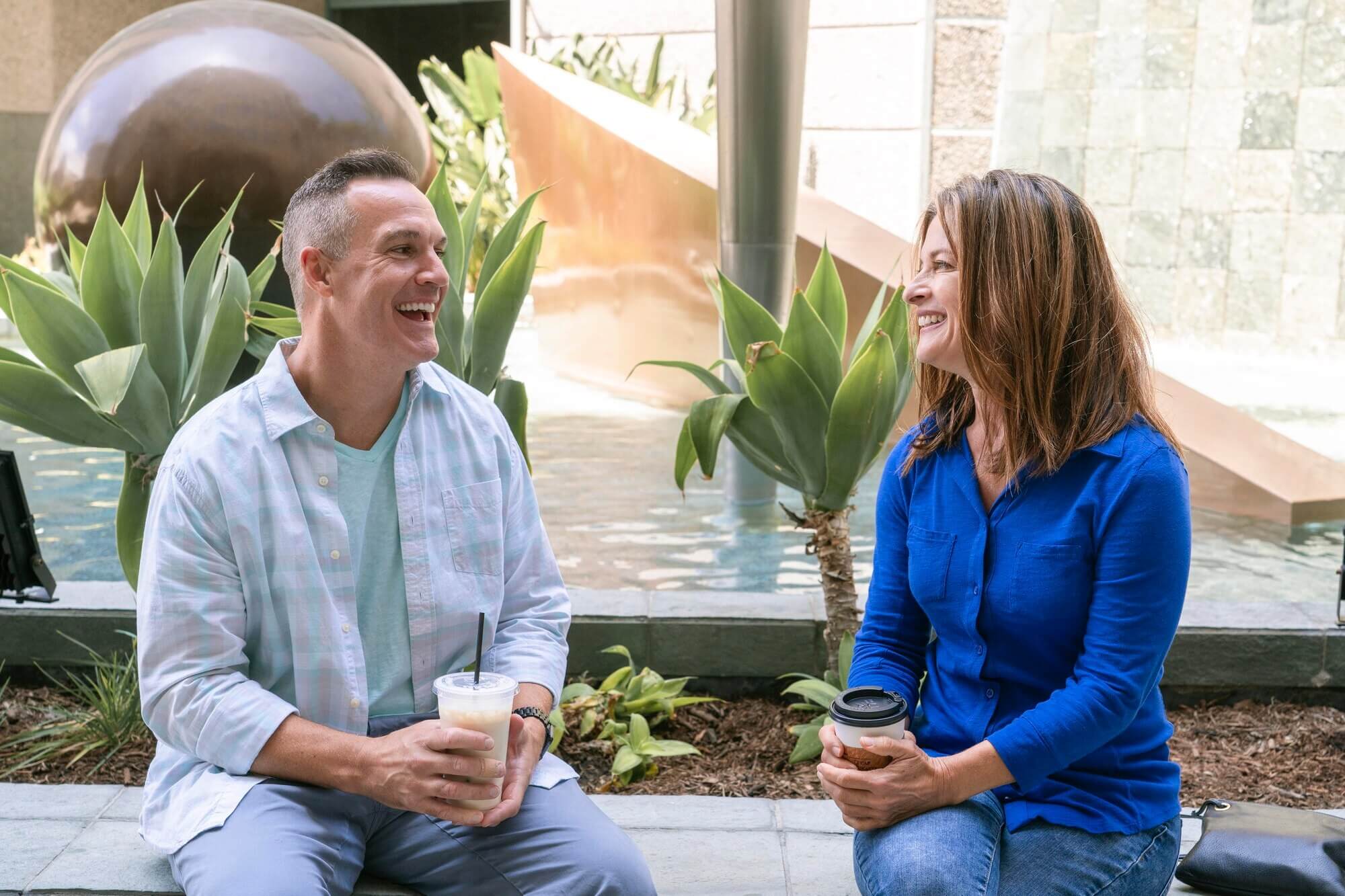 Smiling man and woman on a coffee date, enjoying conversation—ideal for dating after being single for a long time